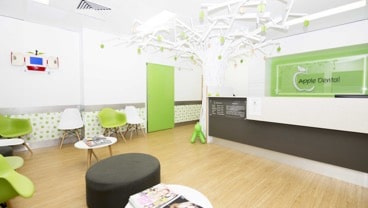 Green, White and Brown Apple Dental Waiting Area with Chairs and Tables